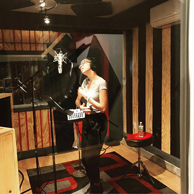 Tahira Clayton singing in a recording studio